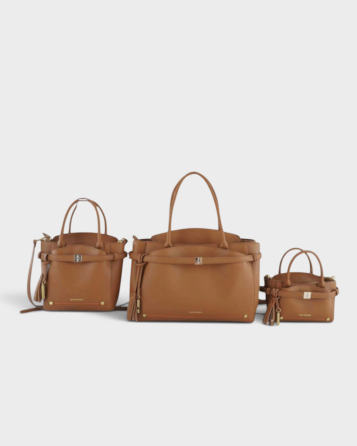 Montemaré Mayfair Work Tote collection in tan leather featuring three different sizes with tassel and buckle details
