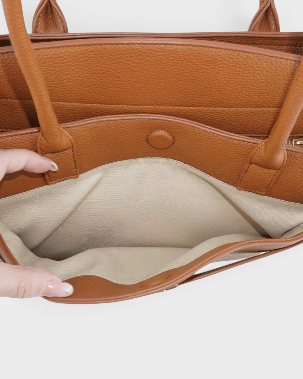 Montemaré Mayfair Work Tote in tan pebbled leather with a beige fabric interior lining and magnetic snap closure.