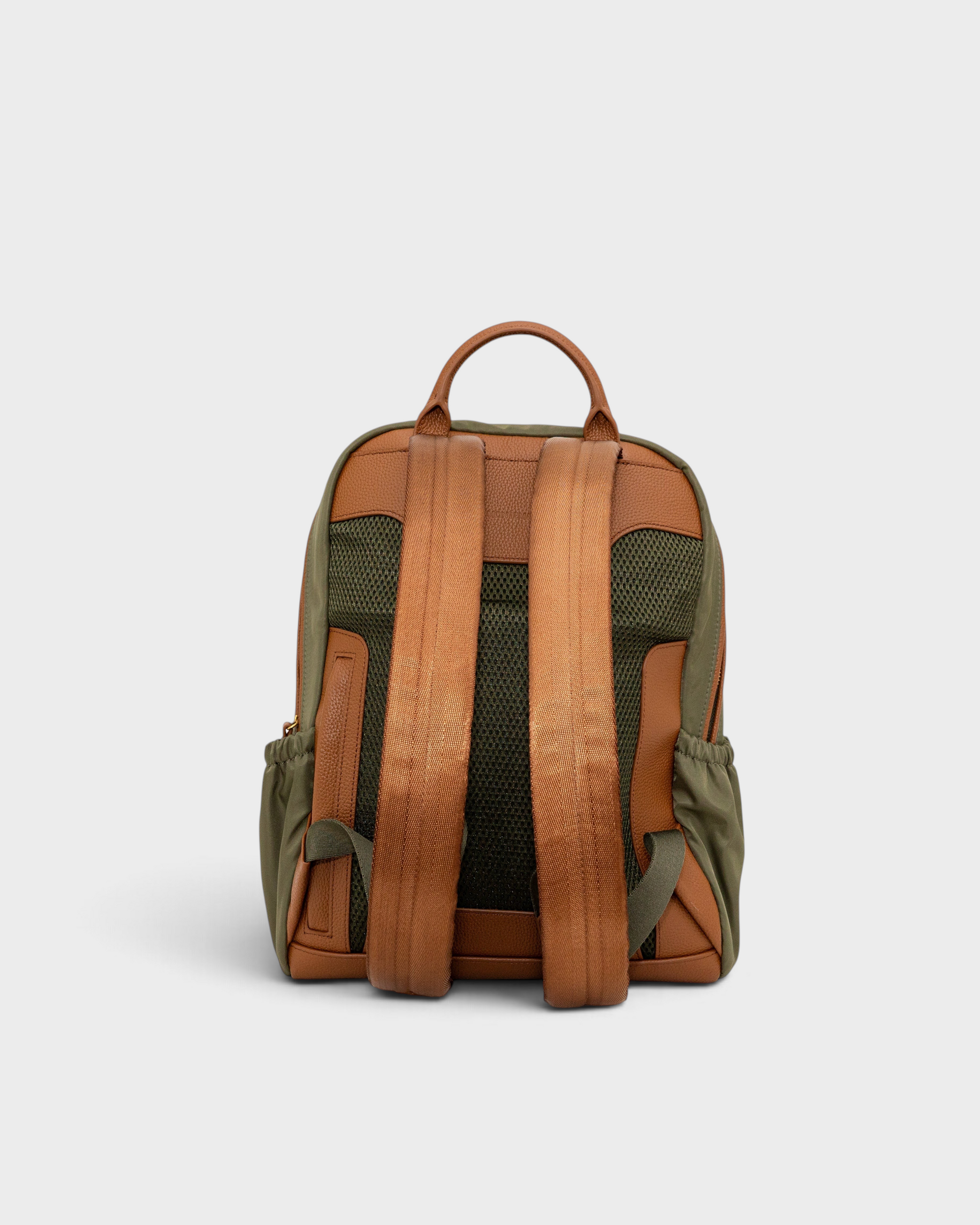 Montemaré Oslo backpack in olive green nylon and tan leather, showing the padded back panel and adjustable straps.