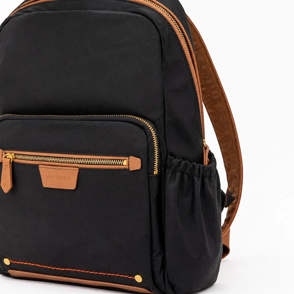Montemaré Oslo backpack in black waterproof nylon with brown leather trim, front zipper pocket, and side pockets.