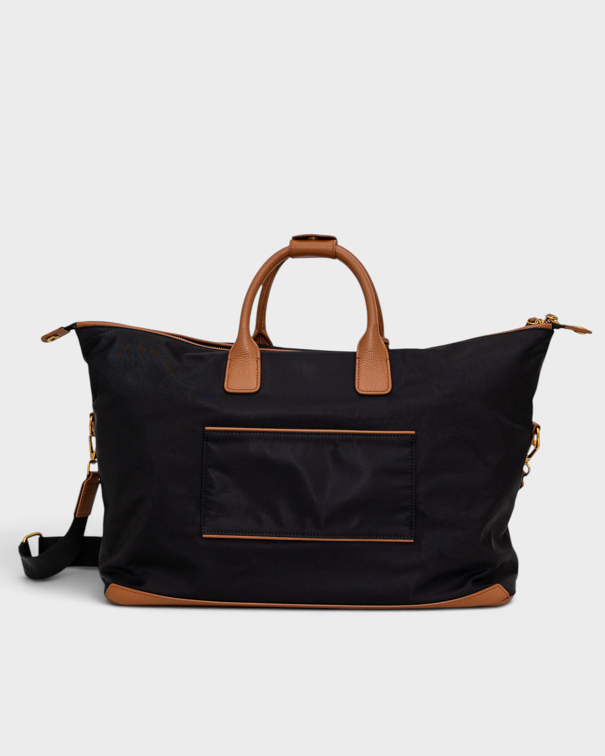 Montemaré Oslo black waterproof nylon weekender bag with tan leather handles and trim on a white background.