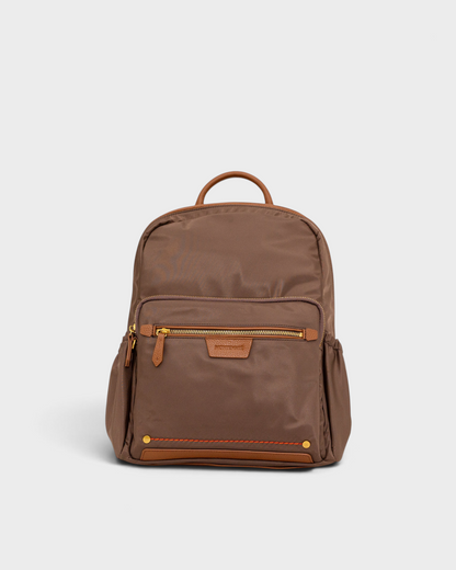 Montemaré Oslo premium brown nylon and leather backpack with gold zippers and front pocket on a light grey background