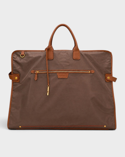 Montemaré Oslo premium brown waterproof nylon garment bag with genuine leather trim and gold hardware details.