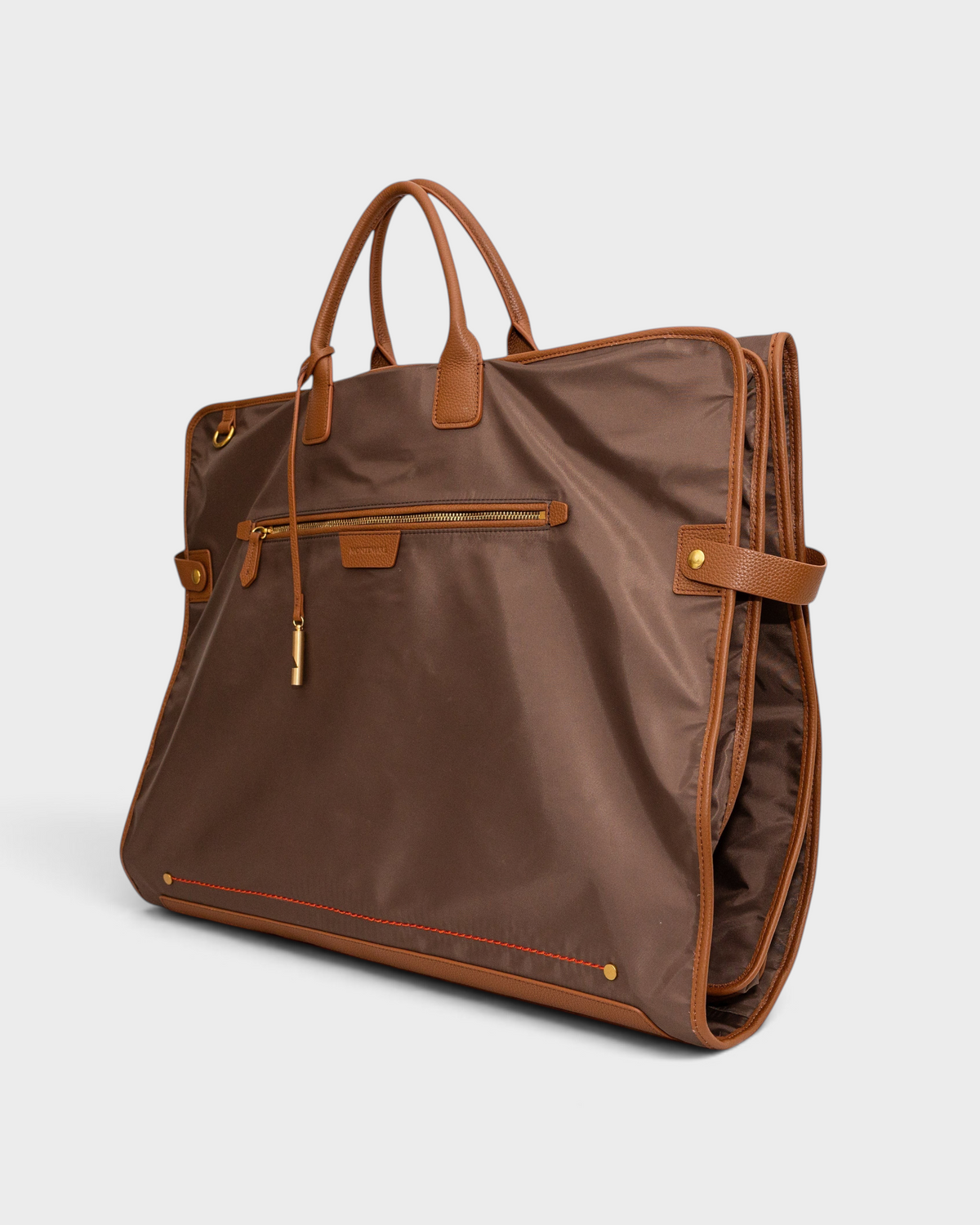 Montemaré Oslo premium brown waterproof nylon tri-fold garment bag with genuine leather trim and gold hardware.
