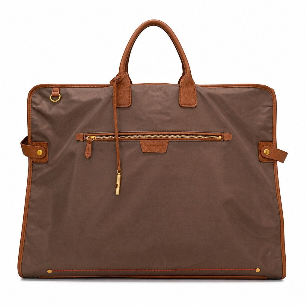 Montemaré Oslo garment bag in brown waterproof nylon with genuine leather trim, gold hardware, and top carry handle.