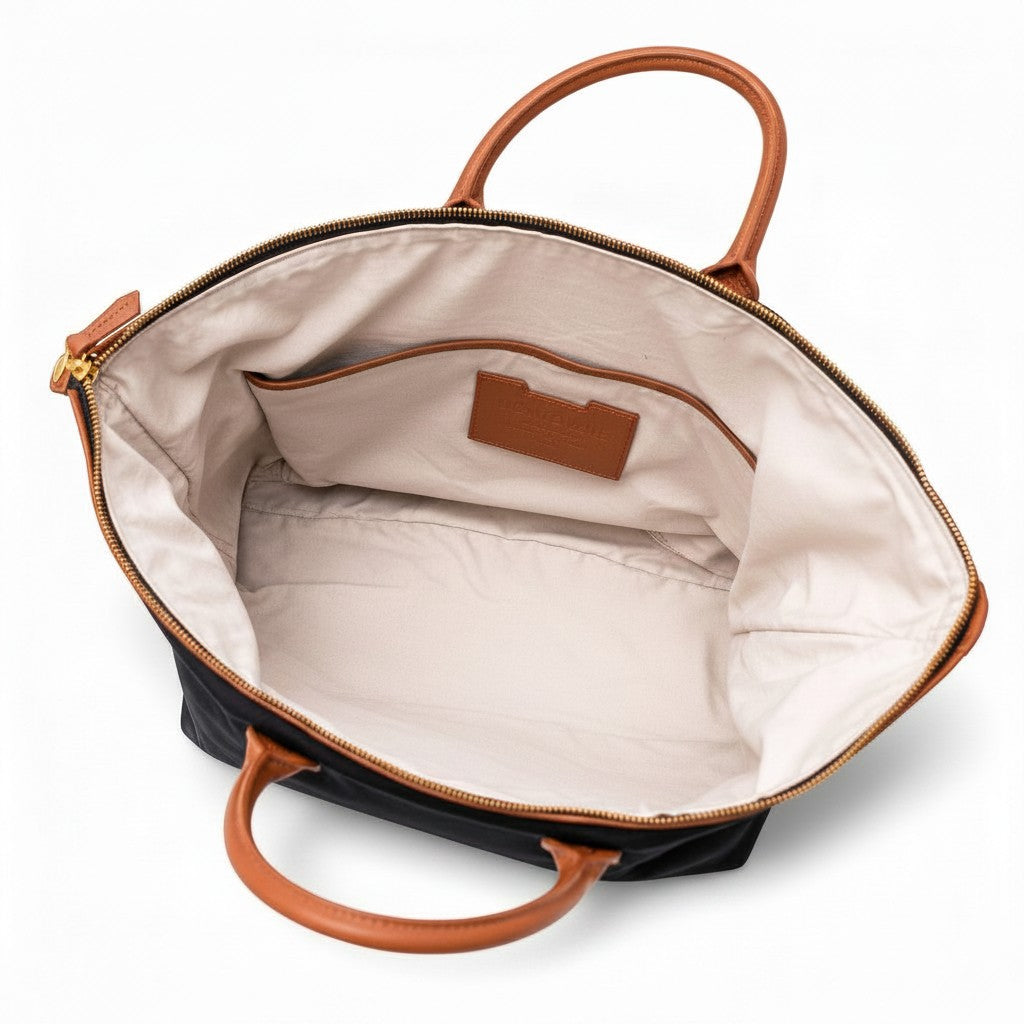 Montemaré Oslo Carry On weekender bag interior with cream cotton lining, leather patch, and tan leather handles.