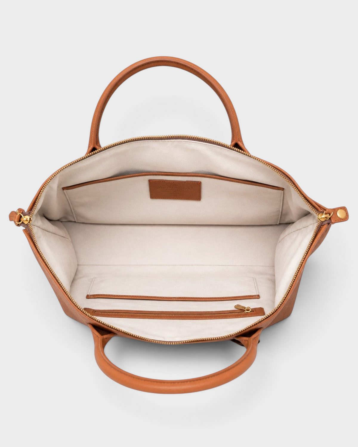 Montemaré Oslo weekender bag interior with cream cotton lining, leather trim, and organizational pockets.