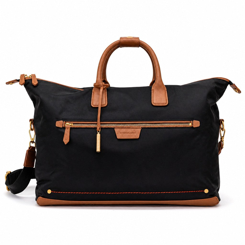 Montemaré Oslo Carry-On weekender bag in black waterproof nylon with tan leather trim and gold hardware.