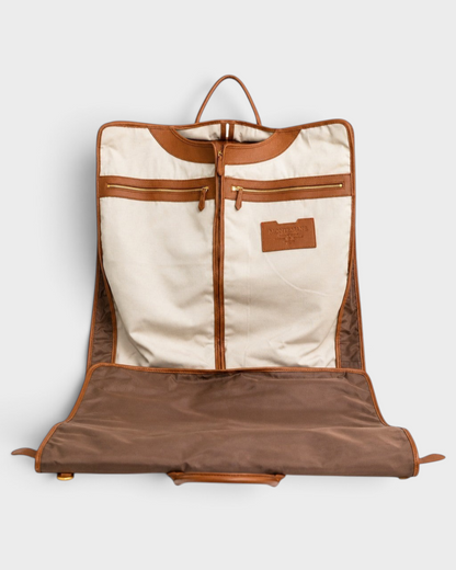 Montemaré Oslo tri-fold garment bag in waterproof nylon with tan leather trim and cream cotton interior lining.