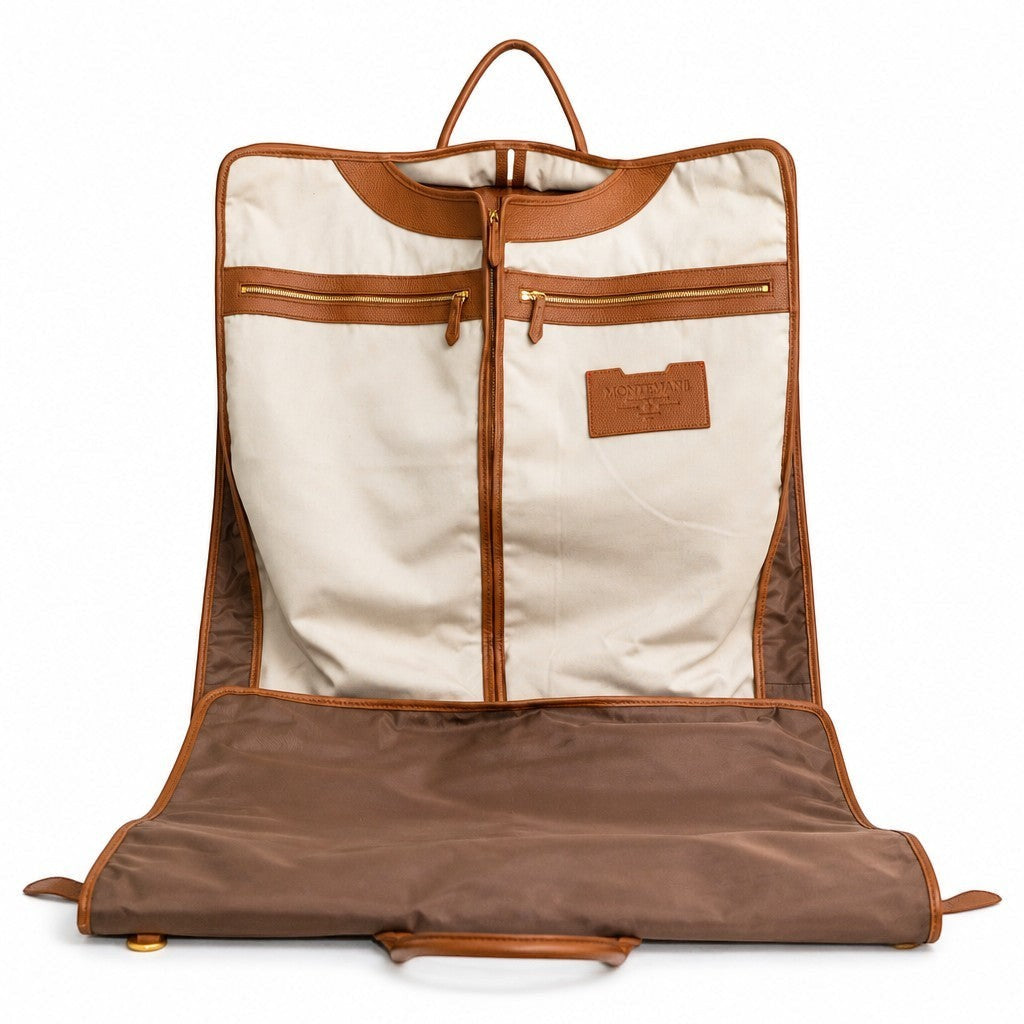 Montemaré Oslo tri-fold garment bag in waterproof nylon with tan leather trim and cream cotton interior lining.