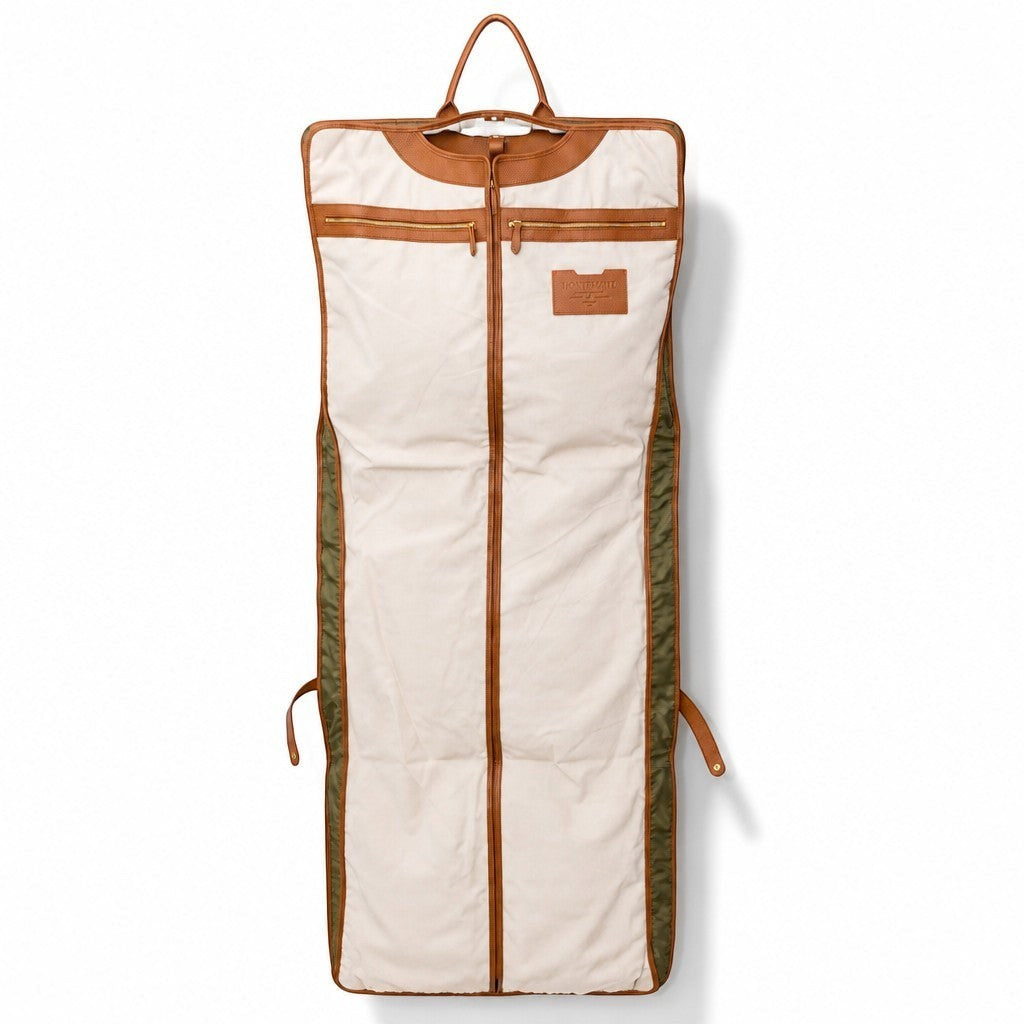 Montemaré Oslo garment bag in beige waterproof nylon with tan leather trim and a top handle, shown unfolded.