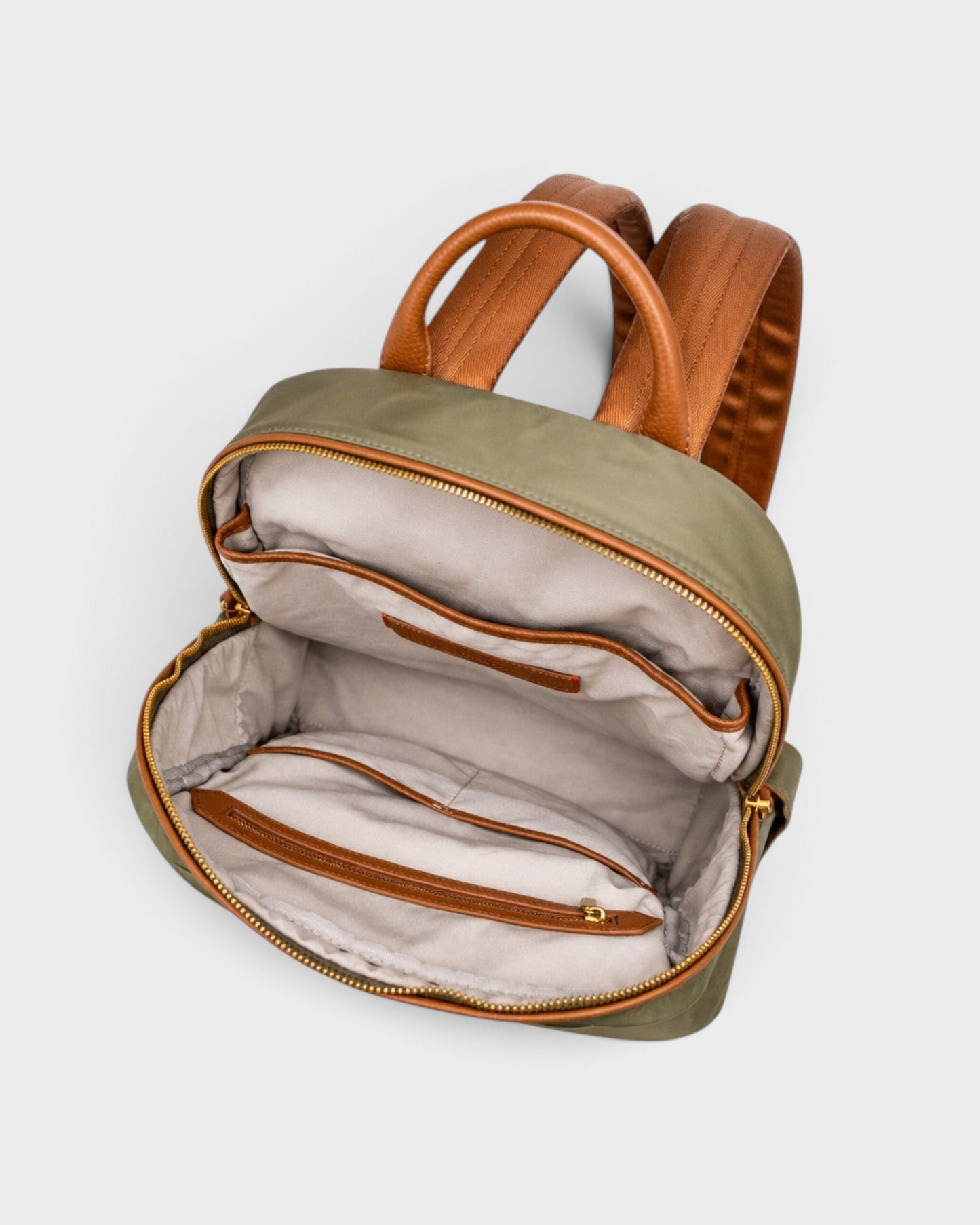 Montemaré Oslo premium backpack in olive green nylon and tan leather with an open interior showing organized pockets.