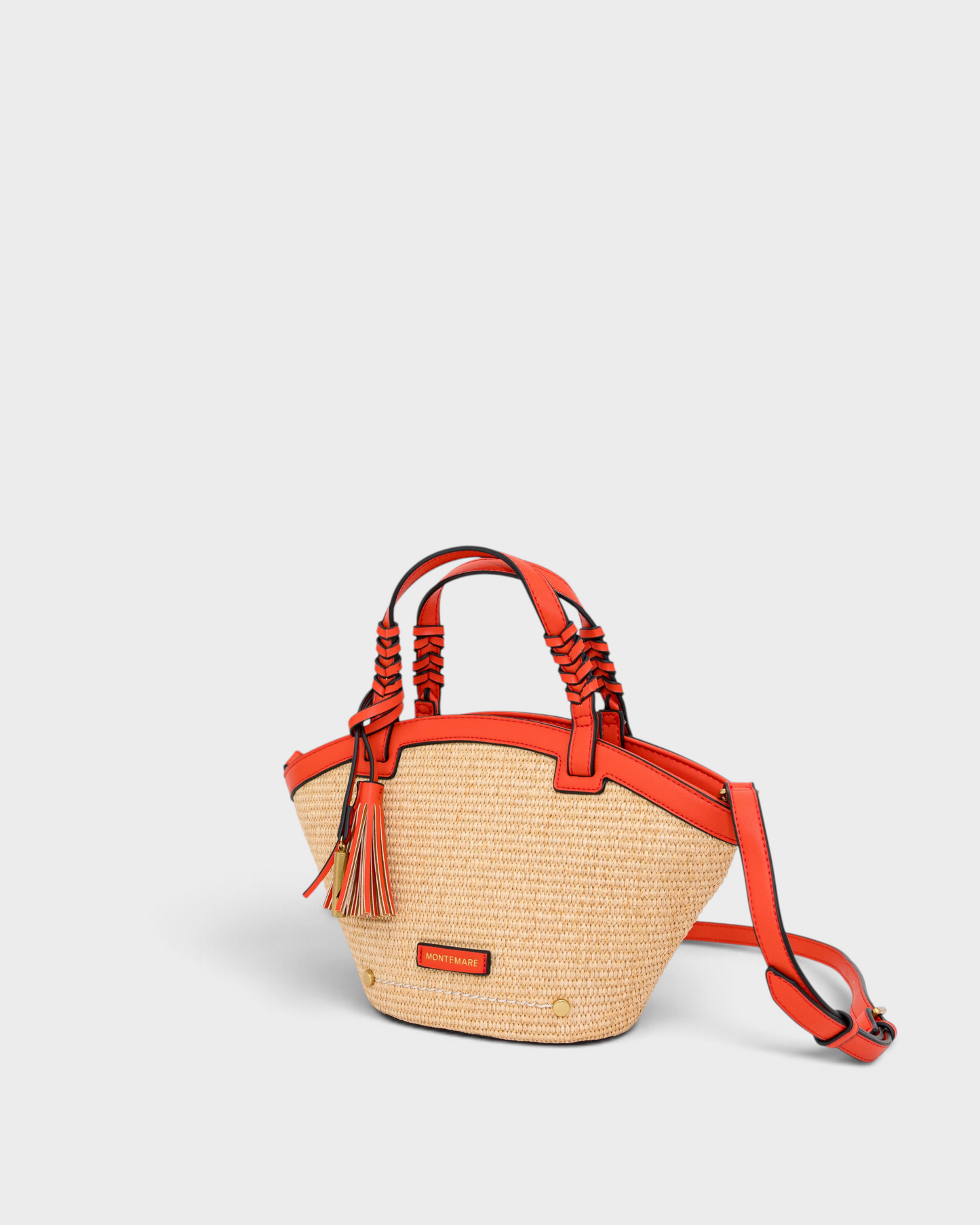 Montemaré Palma straw-style crossbody bag with orange vegan leather trim, top handles, and a safety whistle tassel.