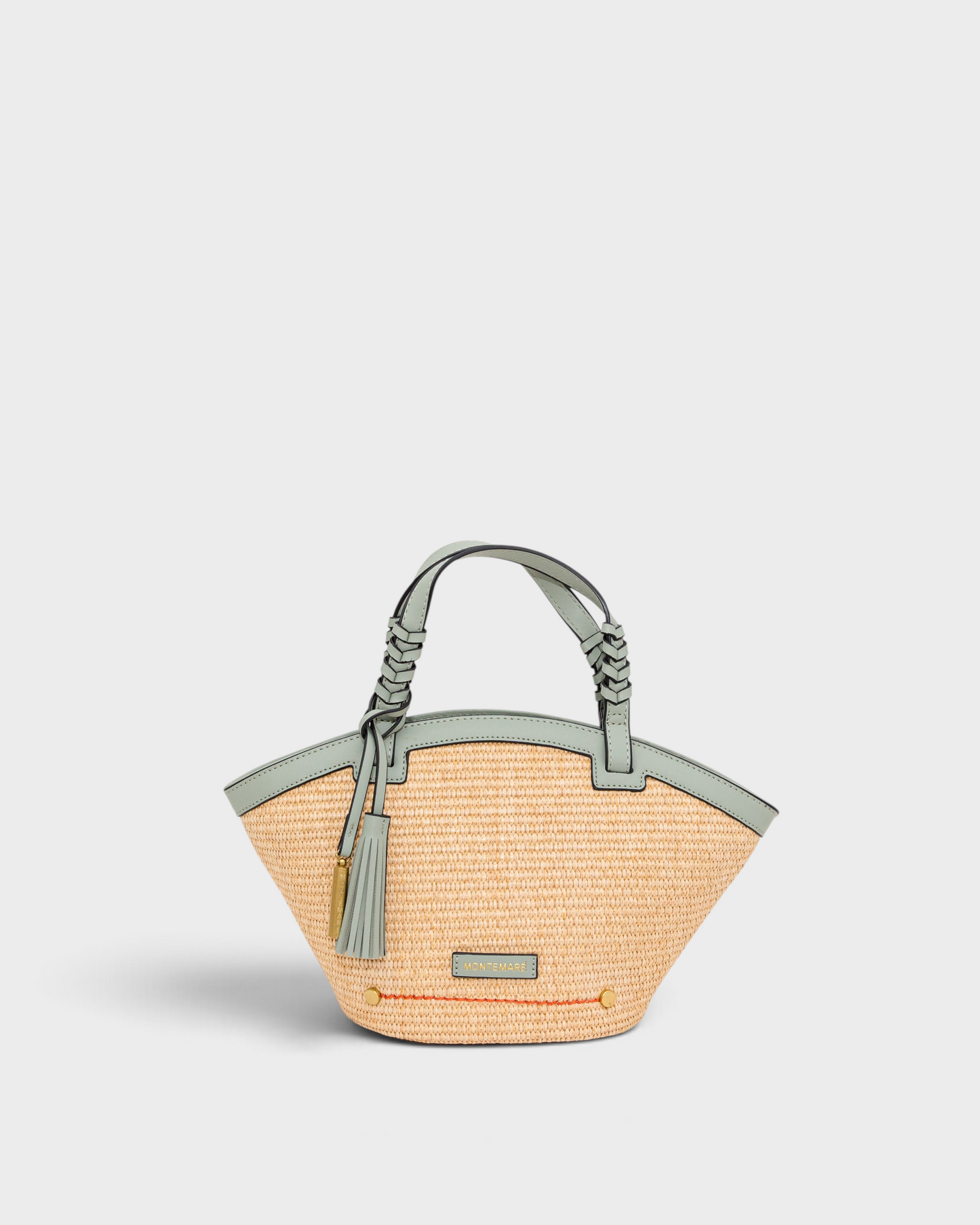 Montemaré Palma straw-style crossbody bag with sage green vegan leather trim, top handles, and a safety whistle tassel.
