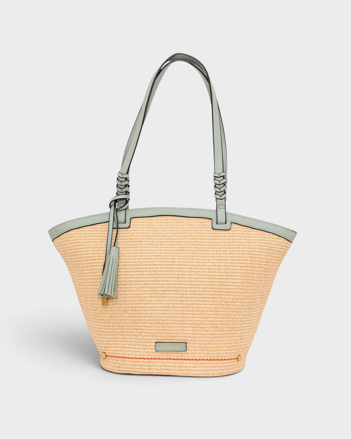 Montemaré Palma Tote in straw-like material with sage green vegan leather straps and a matching safety whistle tassel.