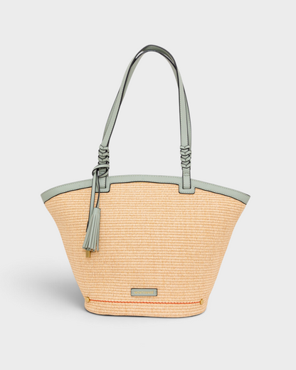 Montemaré Palma Tote in straw-like material with sage green vegan leather straps and a matching safety whistle tassel.