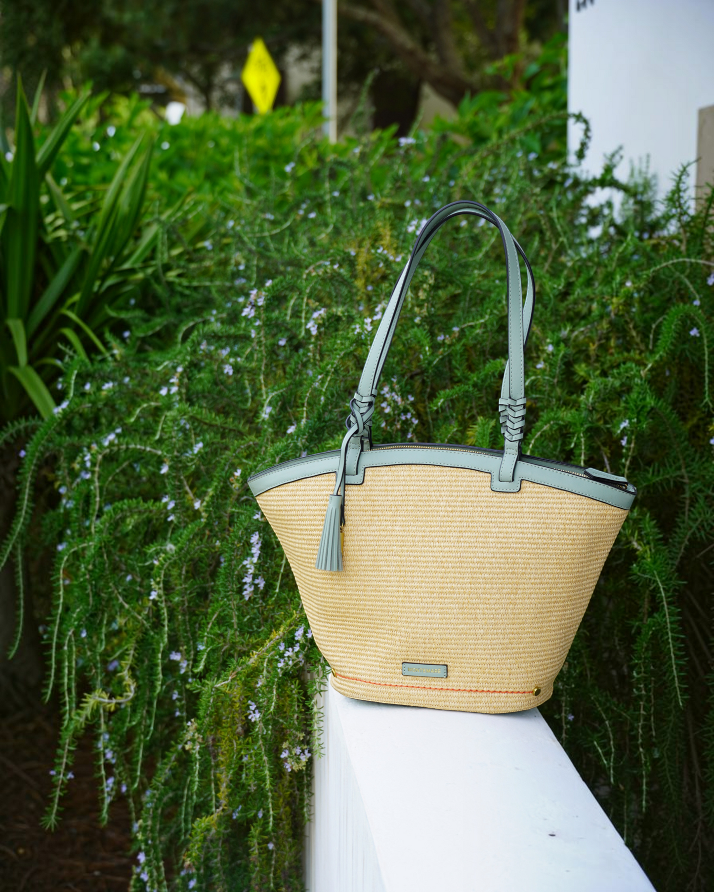 Montemaré Palma Tote bag in straw-like material with sage green vegan leather trim and a signature safety whistle tassel
