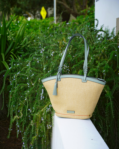 Montemaré Palma Tote bag in straw-like material with sage green vegan leather trim and a signature safety whistle tassel