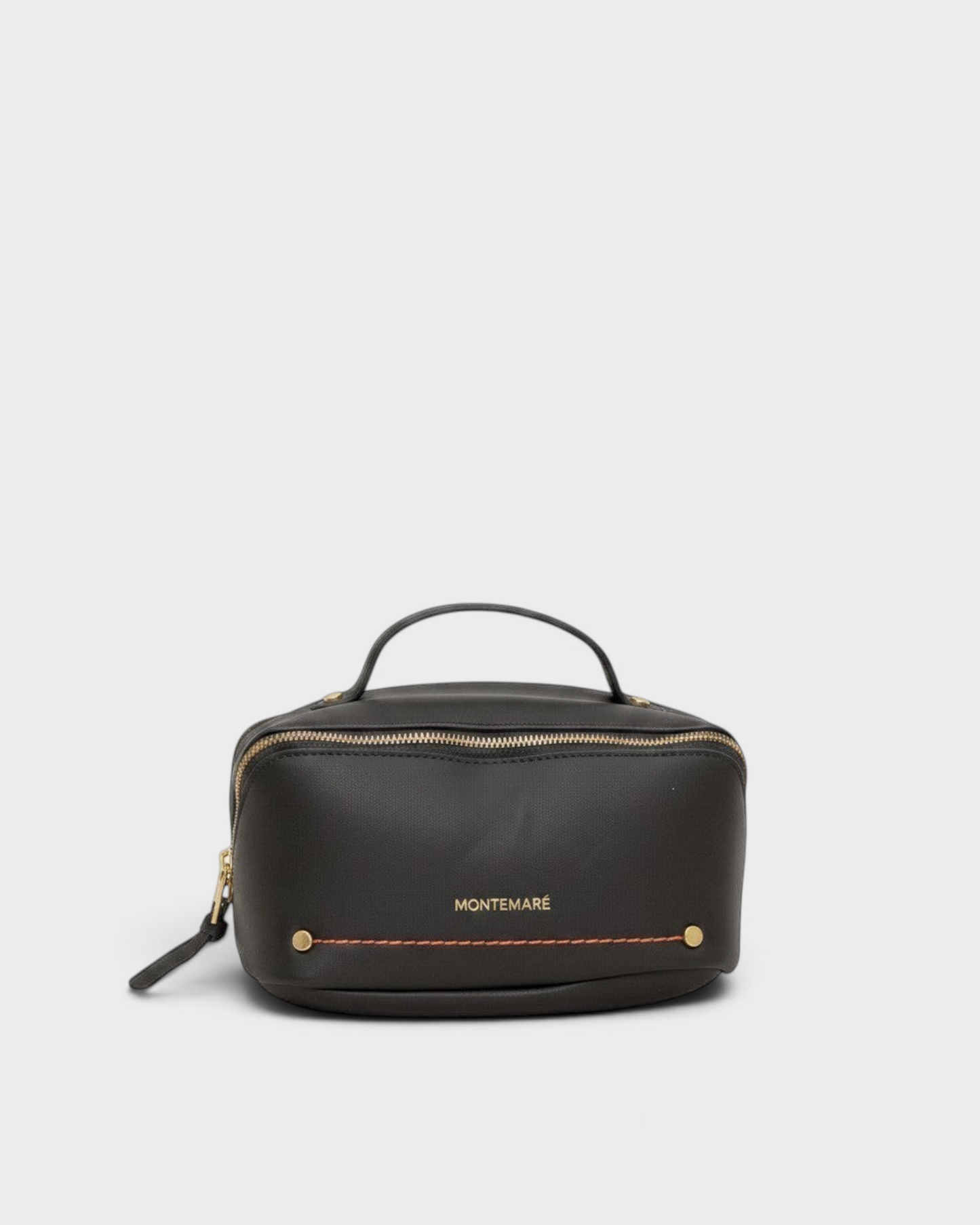 Montemaré Roma black vegan leather toiletry case with a top handle, gold zipper, and orange accent stitching.