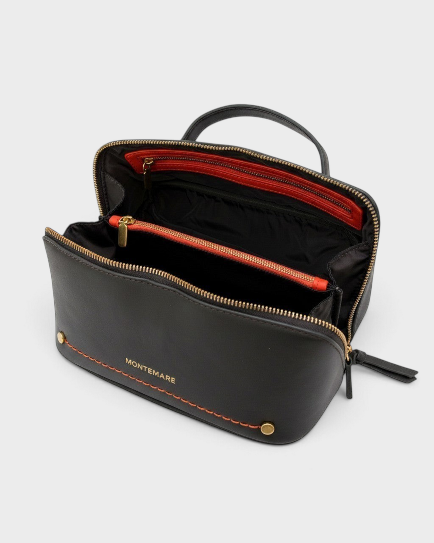 Montemaré Roma foldout toiletry case in black vegan leather with orange accents, top handle, and wide zippered opening