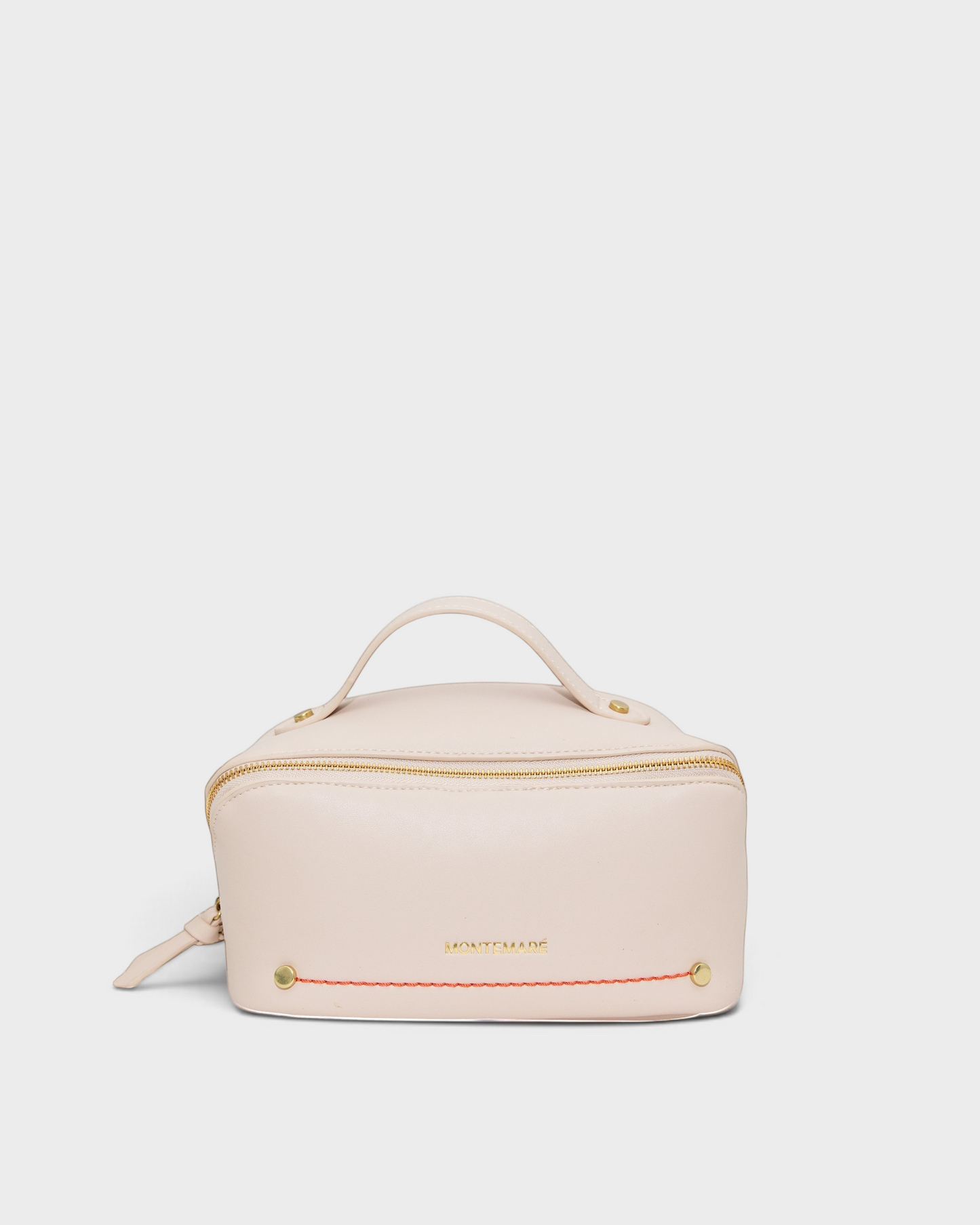 Montemaré Roma foldout toiletry case in blush vegan leather with a top handle and orange accent stitching