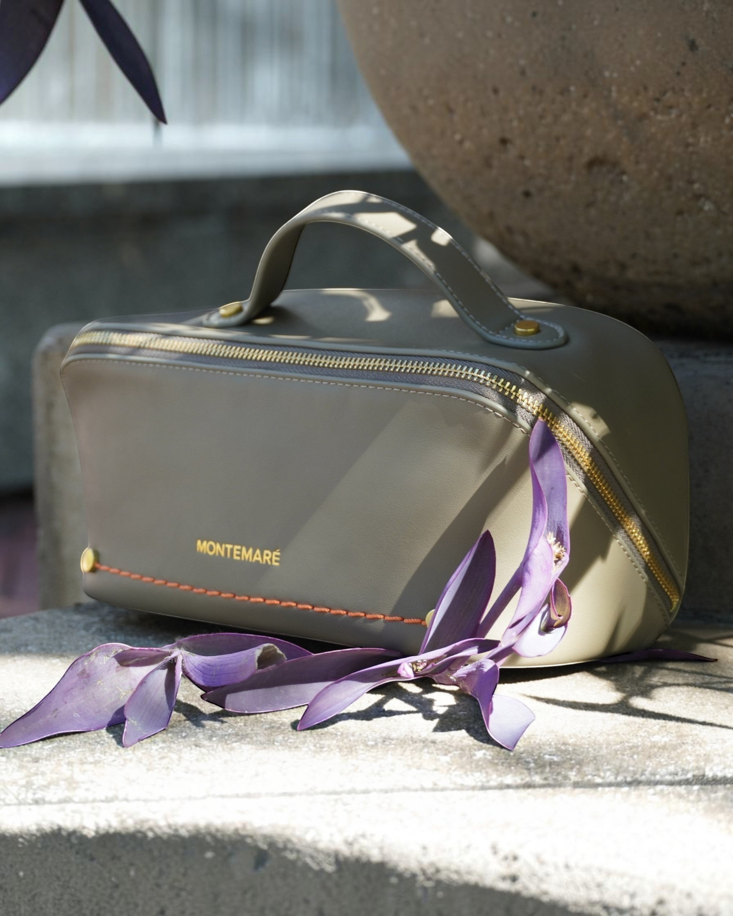 Montemaré Roma foldout toiletry case in olive vegan leather with orange stitching and gold zipper details