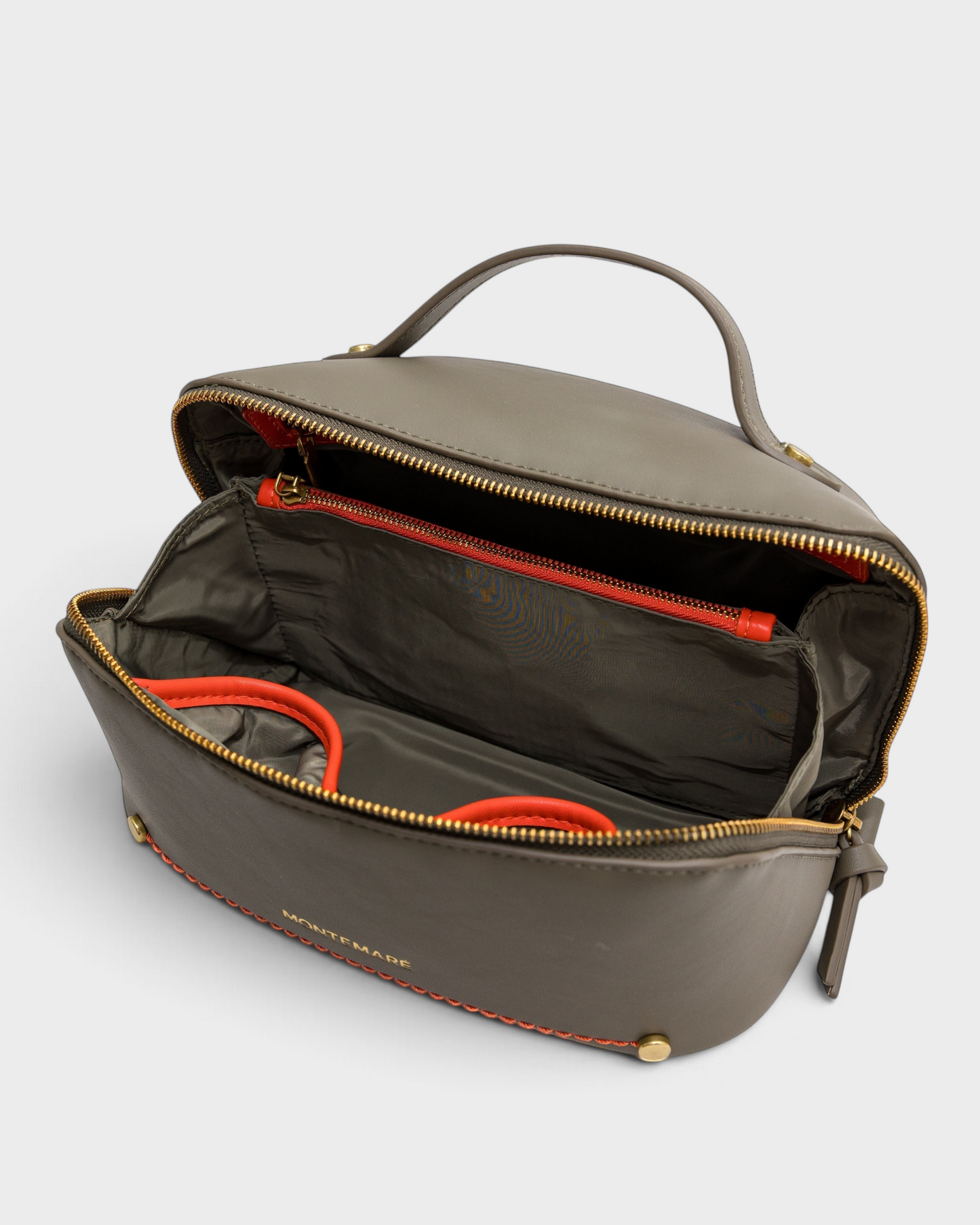 Montemaré Roma foldout toiletry case in grey vegan leather with orange accents, wide opening, and interior pockets.