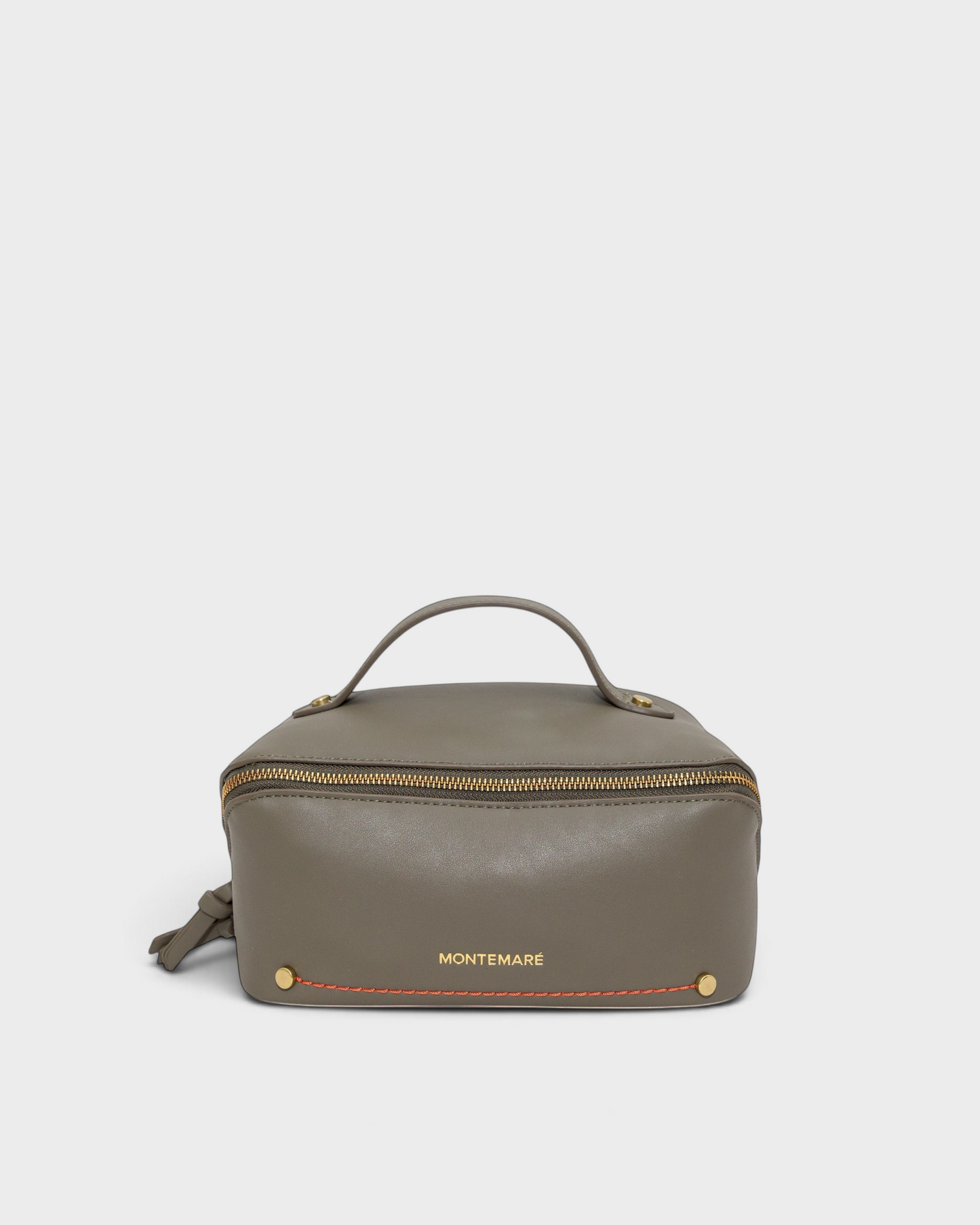 Montemaré Roma foldout toiletry case in grey vegan leather with orange stitching and a top handle on a neutral background
