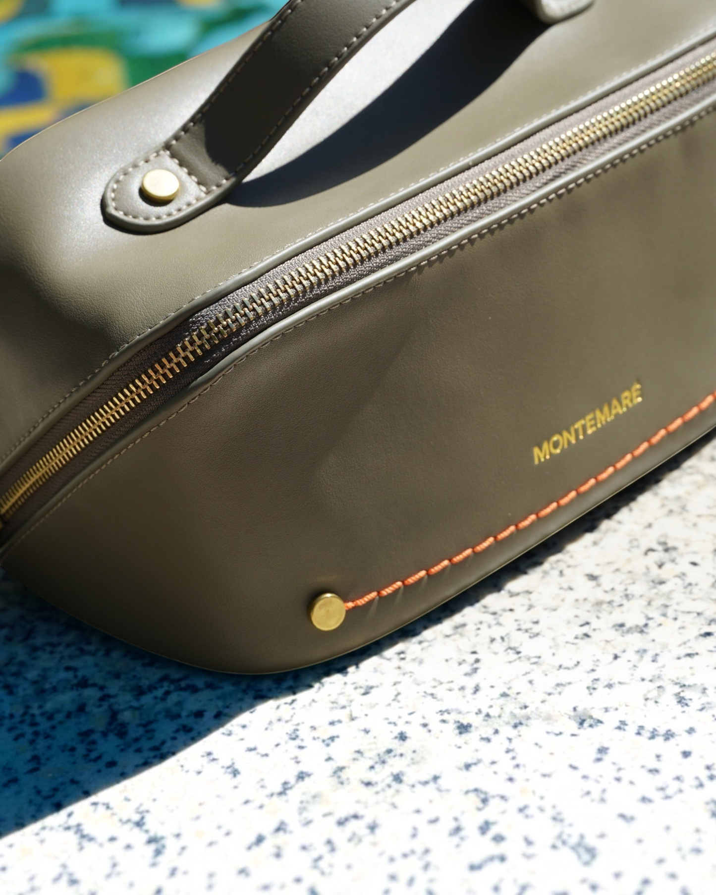 Montemaré Roma foldout toiletry case in olive vegan leather with gold hardware and orange contrast stitching