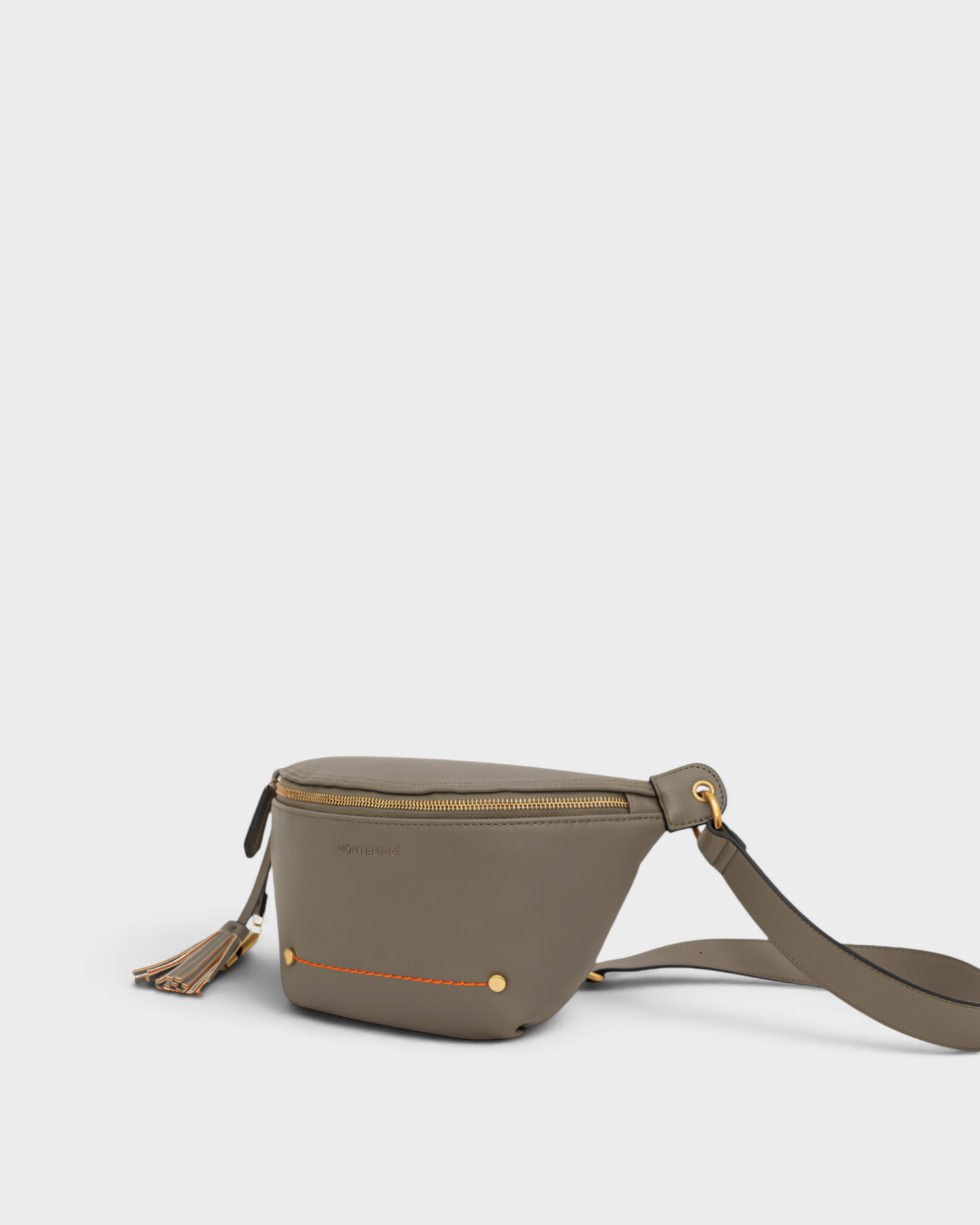 Montemaré Roma Sling bag in olive vegan leather with gold hardware, zip closure, and signature safety whistle tassel.