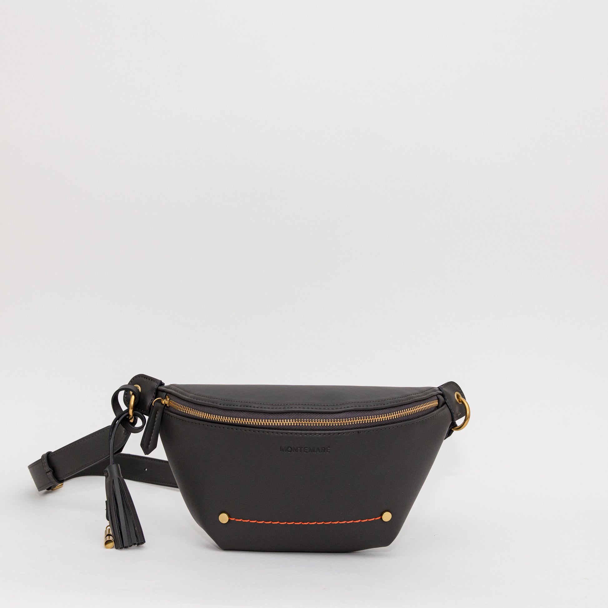 Soft black sling with gold-finished zipper, whistle tassel, and orange stitching on a white background