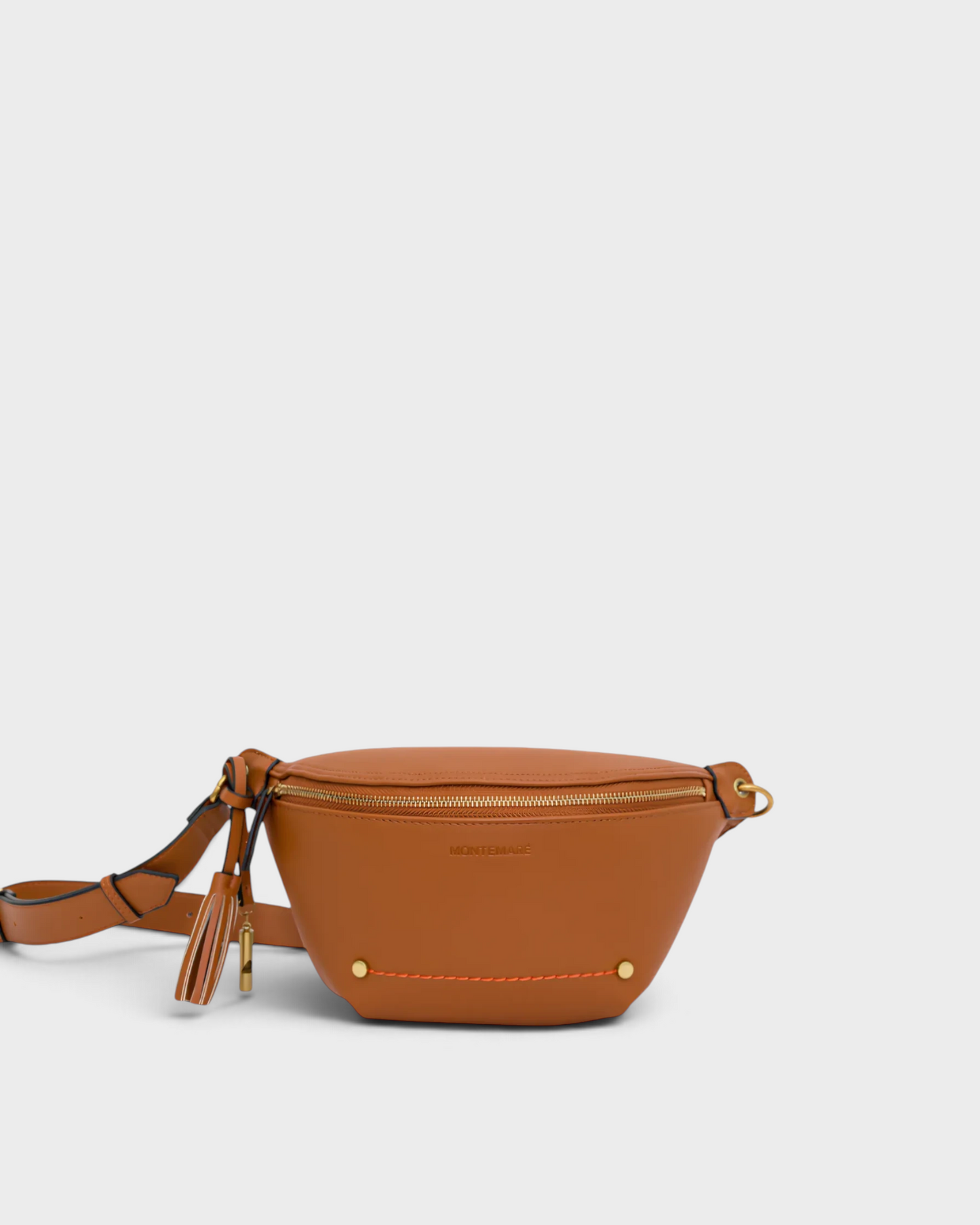 Montemaré Roma Sling bag in tan vegan leather with a signature safety whistle tassel and adjustable crossbody strap.