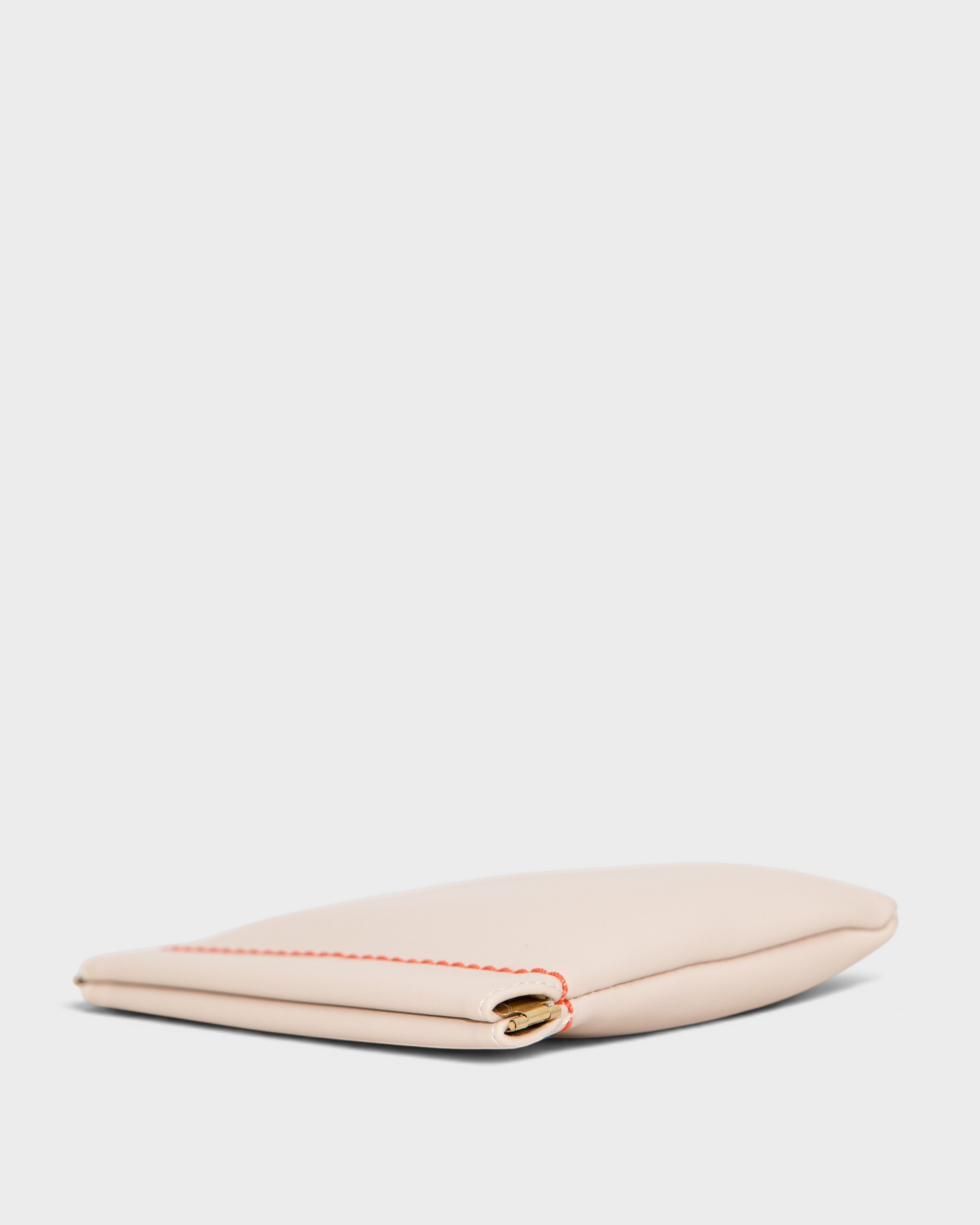 Montemaré Roma Square Pouch in beige vegan leather with a spring-frame closure and contrasting orange stitching.