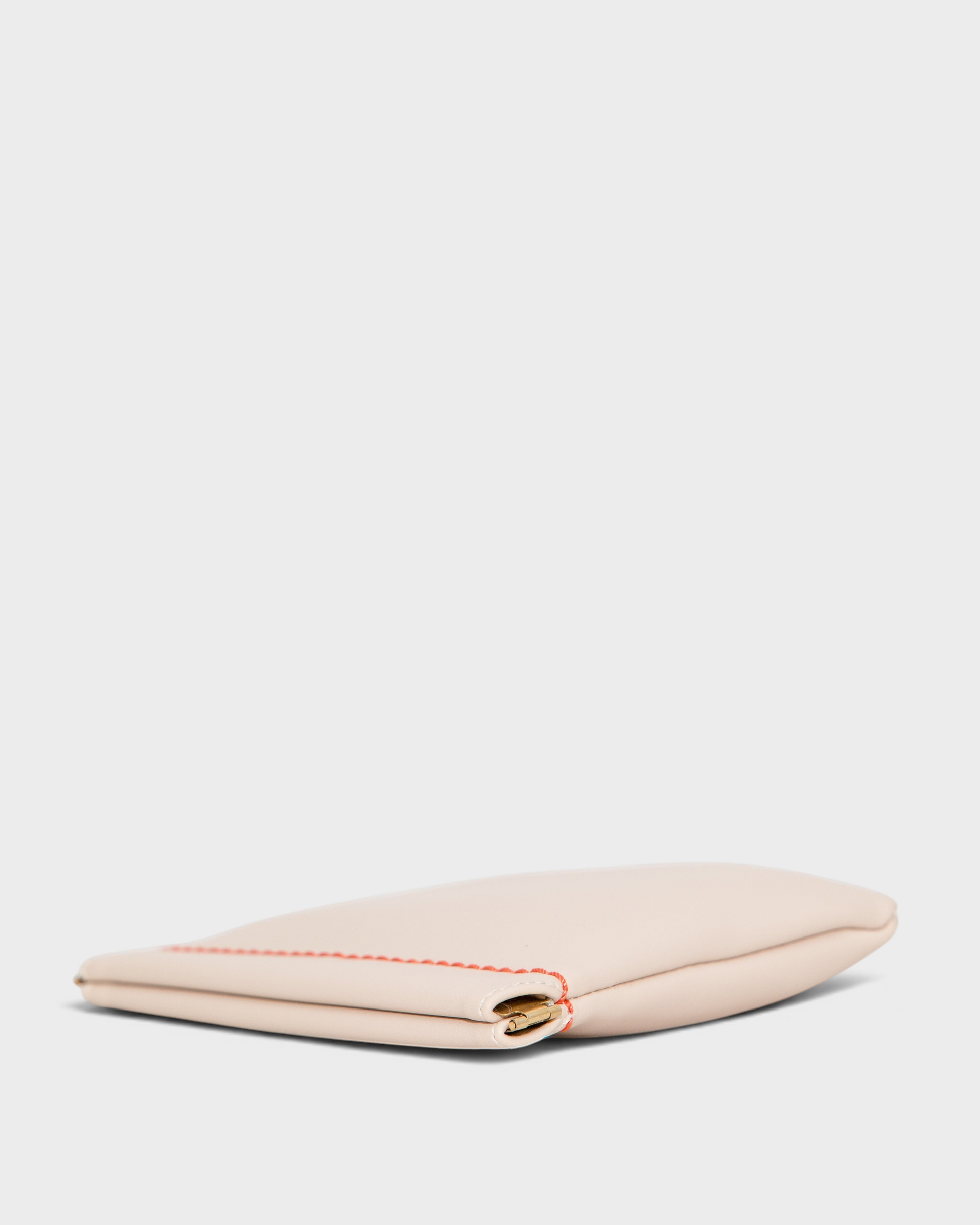 Montemaré Roma Square Pouch in beige vegan leather with a spring-frame closure and contrasting orange stitching.