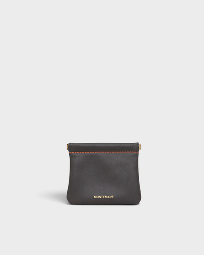 Montemaré Roma square pouch in dark grey vegan leather with orange contrast stitching and spring-frame closure.