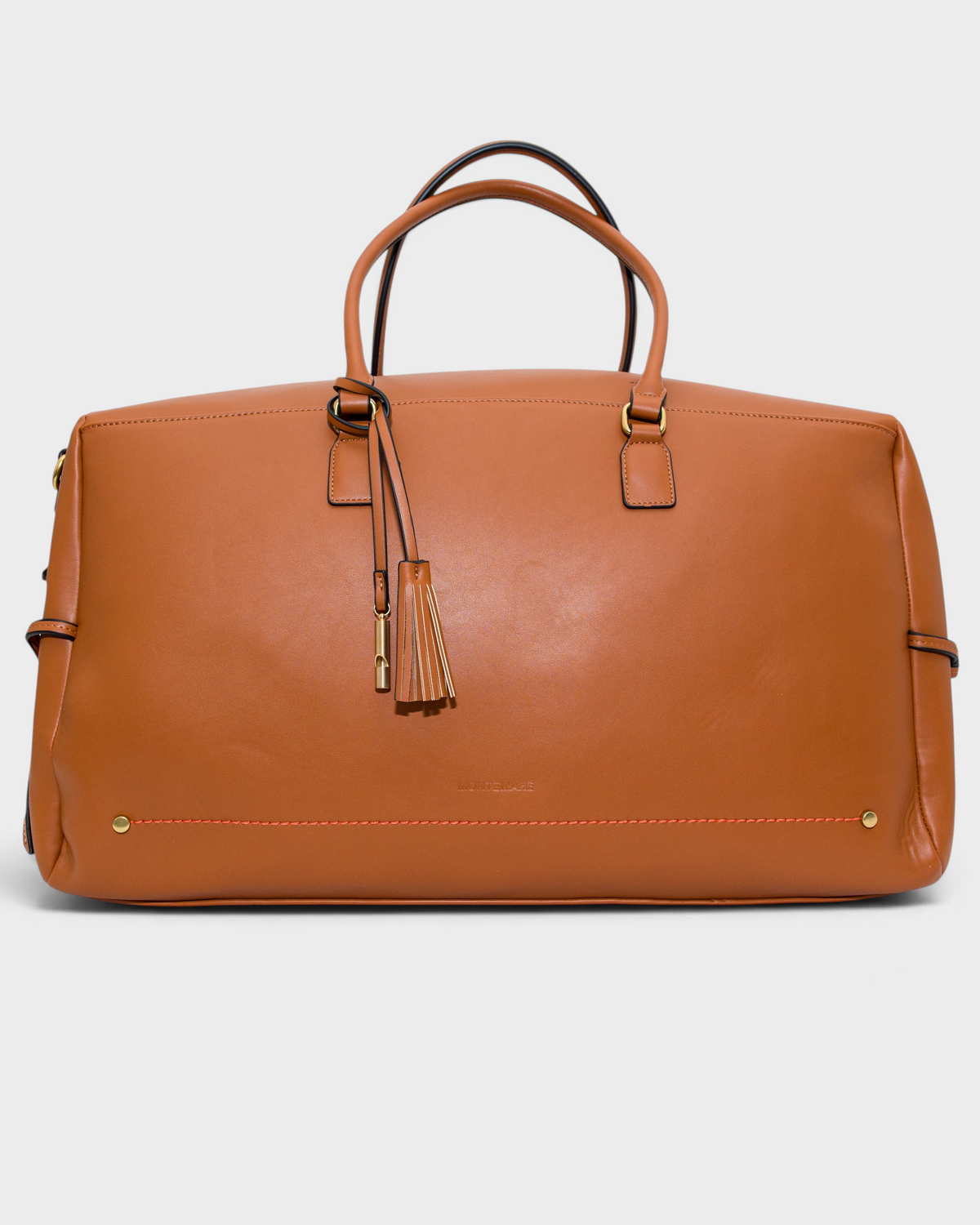 Montemaré Roma tan vegan leather travel duffel bag with gold hardware, top handles, and a decorative tassel.