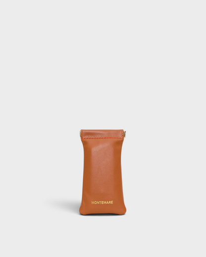Montemaré Roma glasses case in tan vegan leather with a spring-frame closure and gold logo detail.