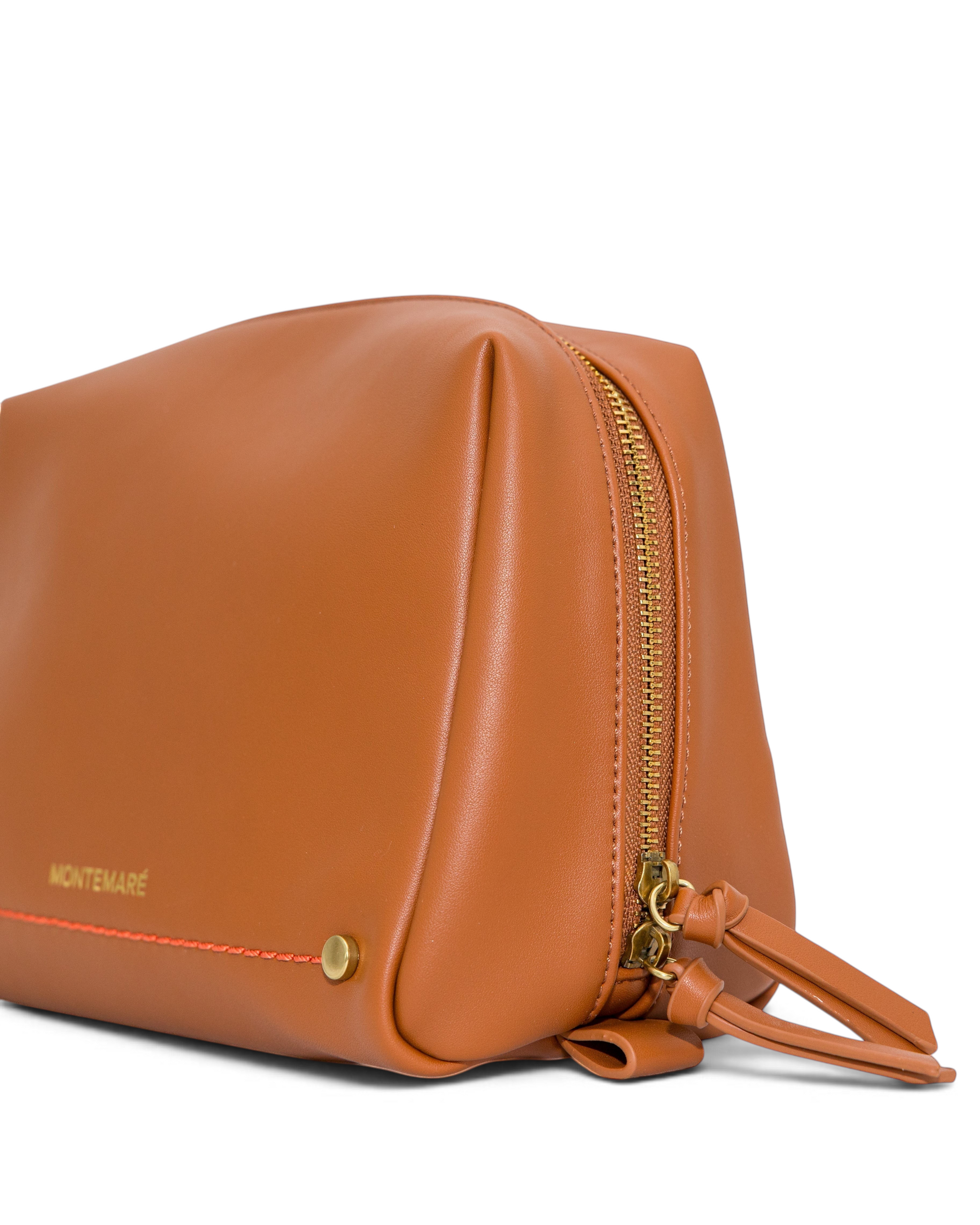 Montemaré Roma standing toiletry case in tan vegan leather with gold zipper and orange accent stitching