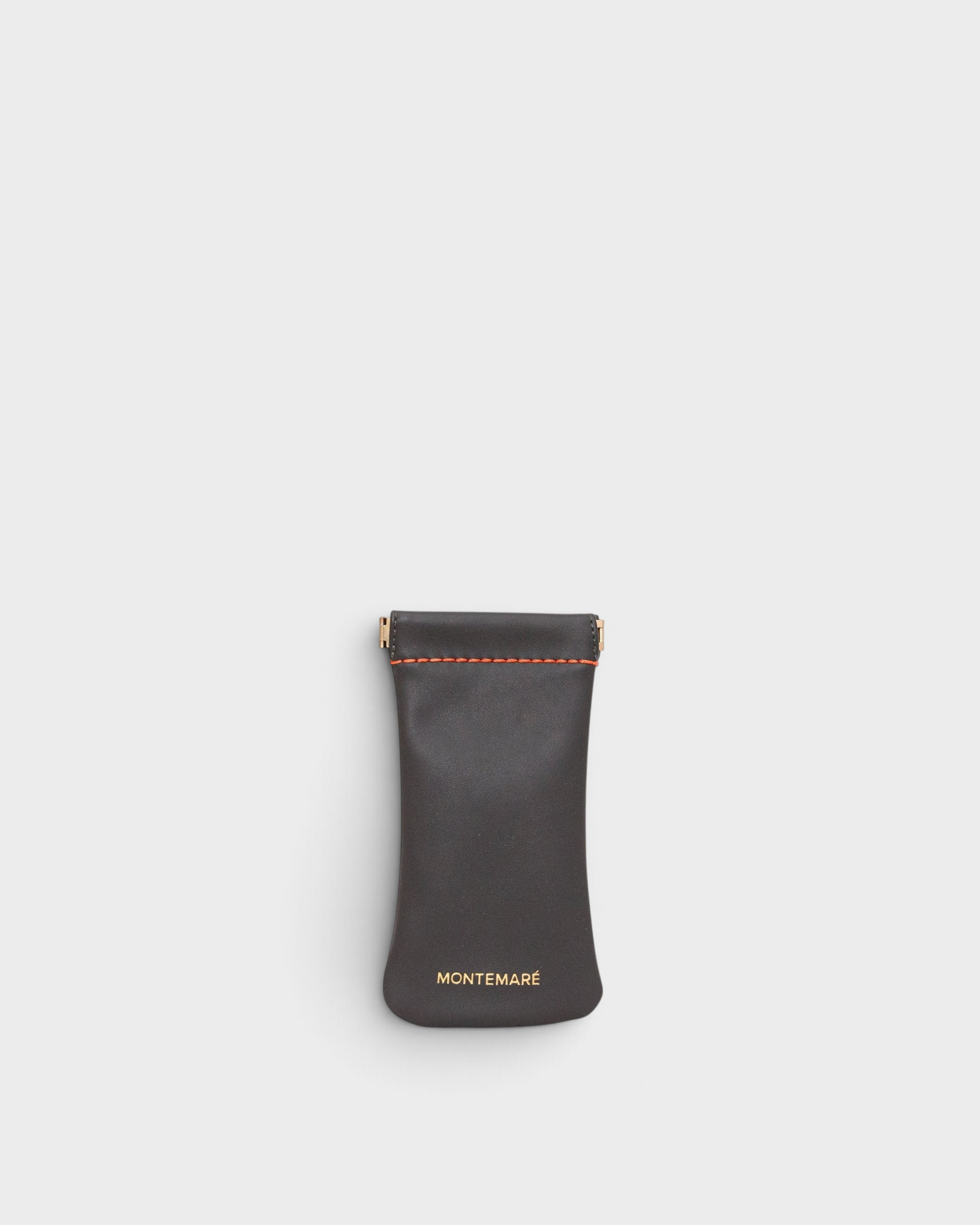 Montemaré Roma glasses case in dark grey vegan leather with orange stitching and a spring-frame closure.