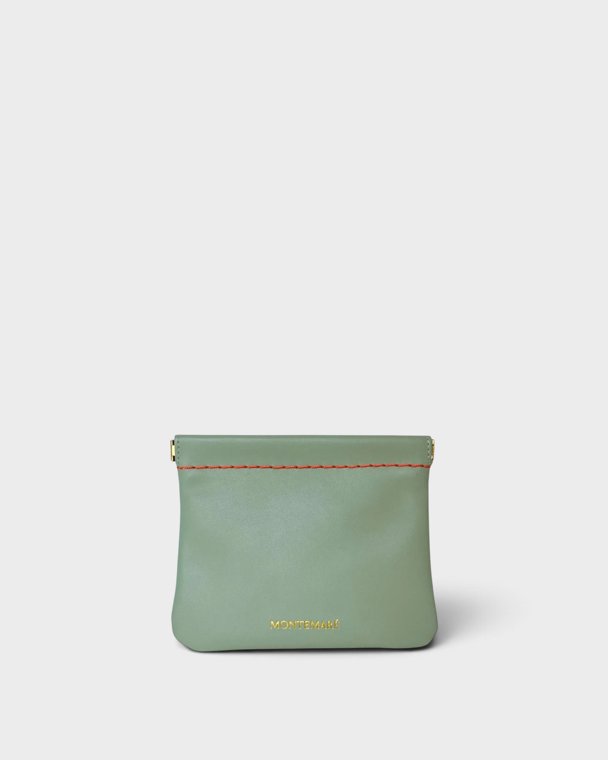 Montemaré sage green vegan leather square pouch with a secure spring-frame closure and contrast stitching.
