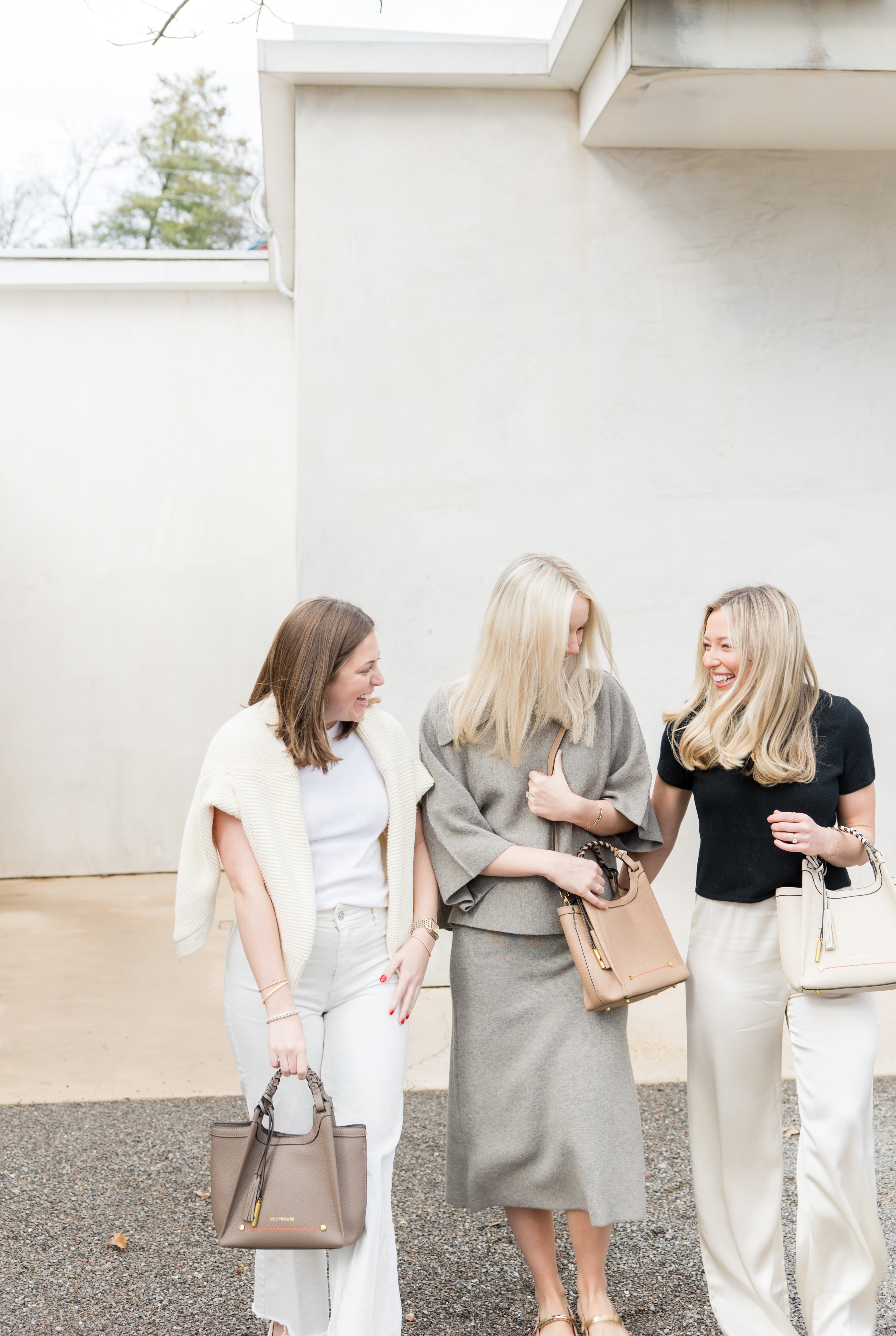Group of girls laughing holding handbags from Montemaré's Sedona Collection
