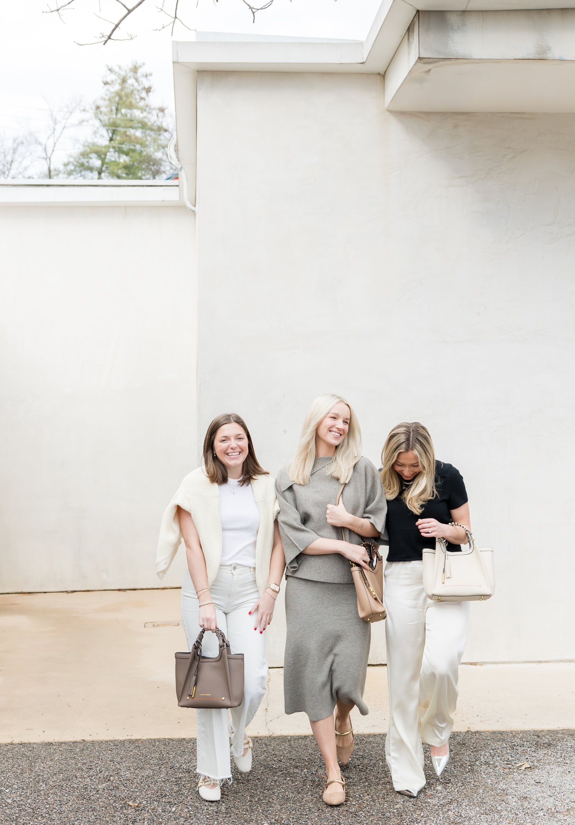 Friends walking down the street carrying classic handbags from Montemaré Sedona Collection