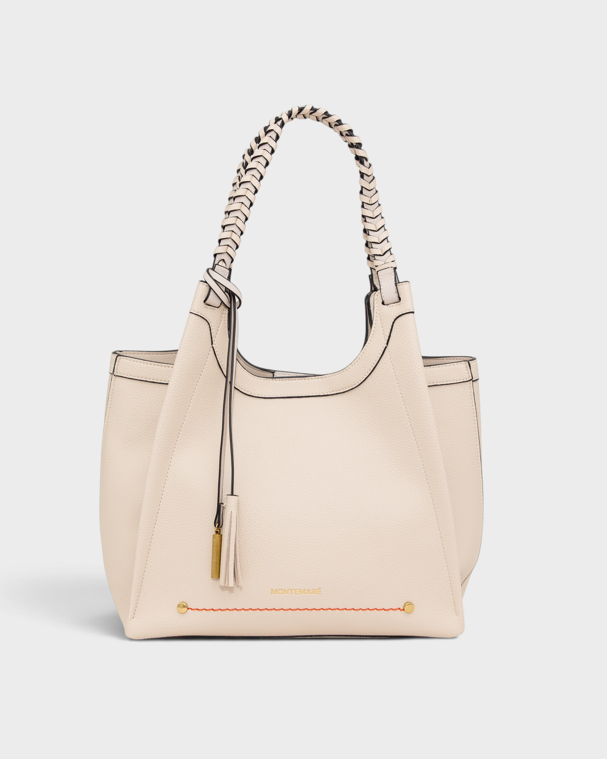 Montemaré Sedona tote bag in cream vegan leather with hand-braided straps, orange accent stitching, and whistle tassel.