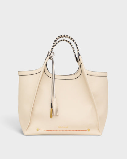 Montemaré Sedona work tote in cream vegan leather with hand-braided handles and signature whistle tassel.