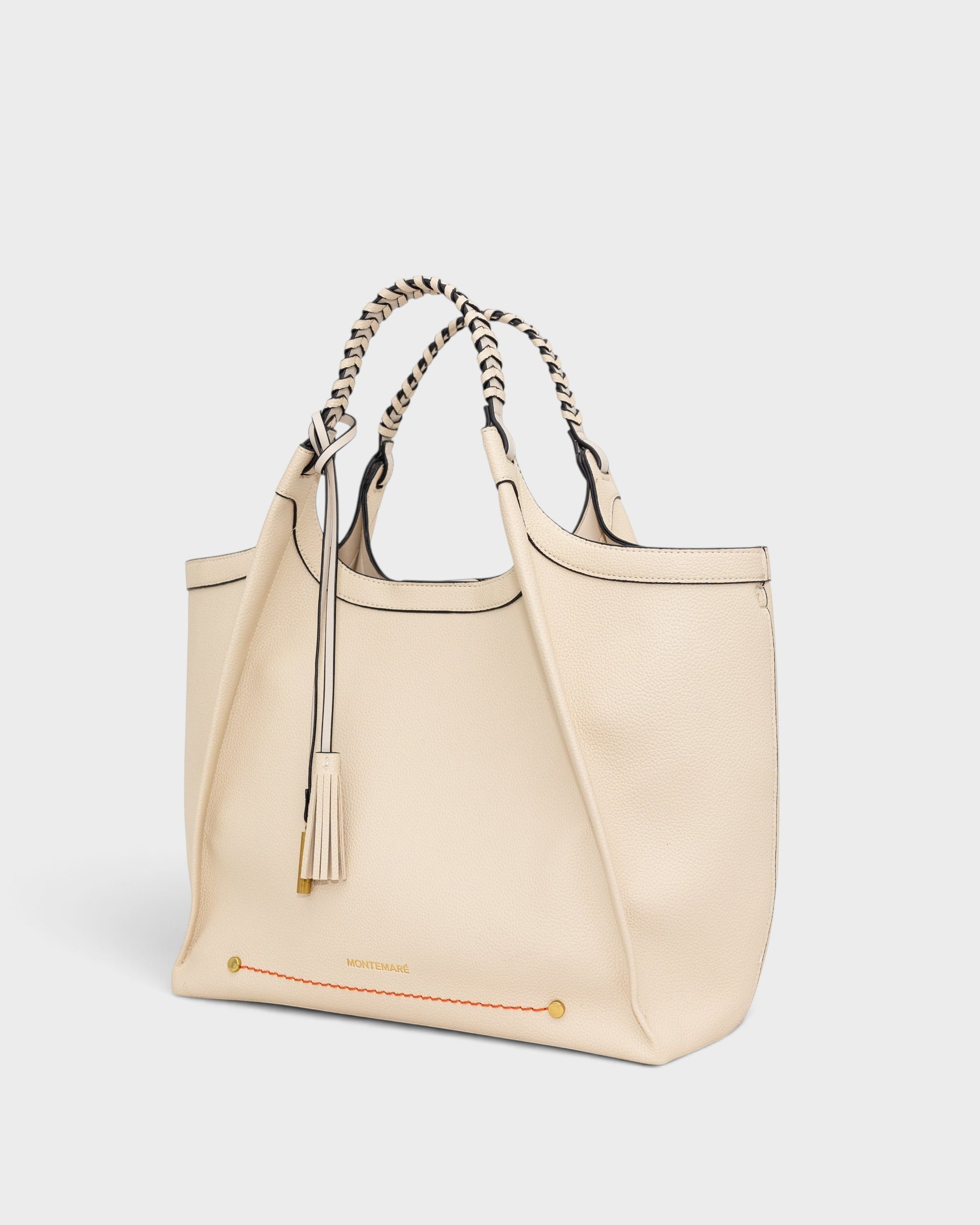Montemaré Sedona Work Tote in cream pebbled vegan leather with hand-braided handles and a signature whistle tassel.