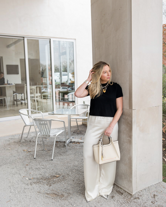 Montemaré Sedona Crossbody bag in cream vegan leather with a braided handle and signature whistle tassel.