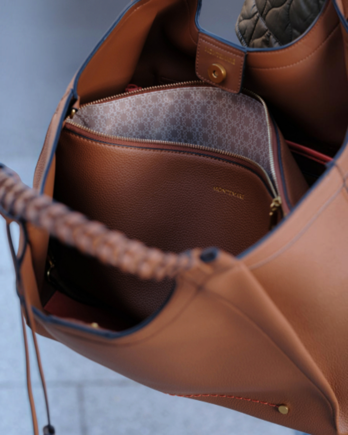 Montemaré Sedona work tote in tan vegan leather with hand-braided handles, interior laptop sleeve, and orange accents.