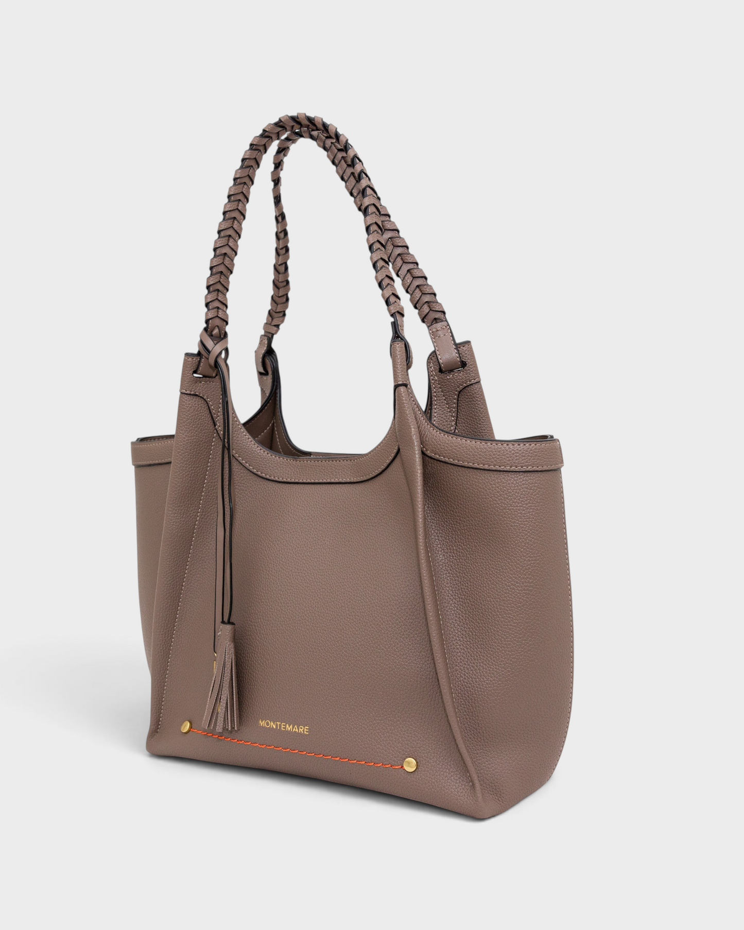 Montemaré Sedona tote in taupe vegan leather with hand-braided straps, orange stitching, and a signature tassel.