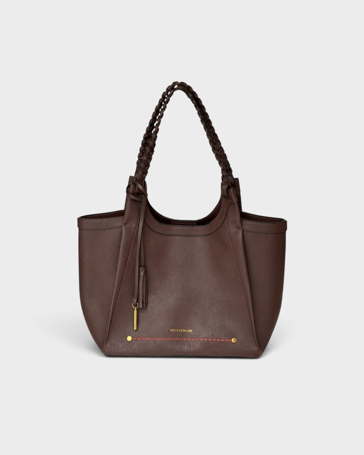 Montemaré Sedona Tote in dark brown vegan leather with hand-braided straps, gold hardware, and a safety whistle tassel