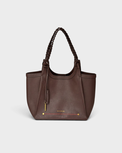 Montemaré Sedona Tote in dark brown vegan leather with hand-braided straps, gold hardware, and a safety whistle tassel